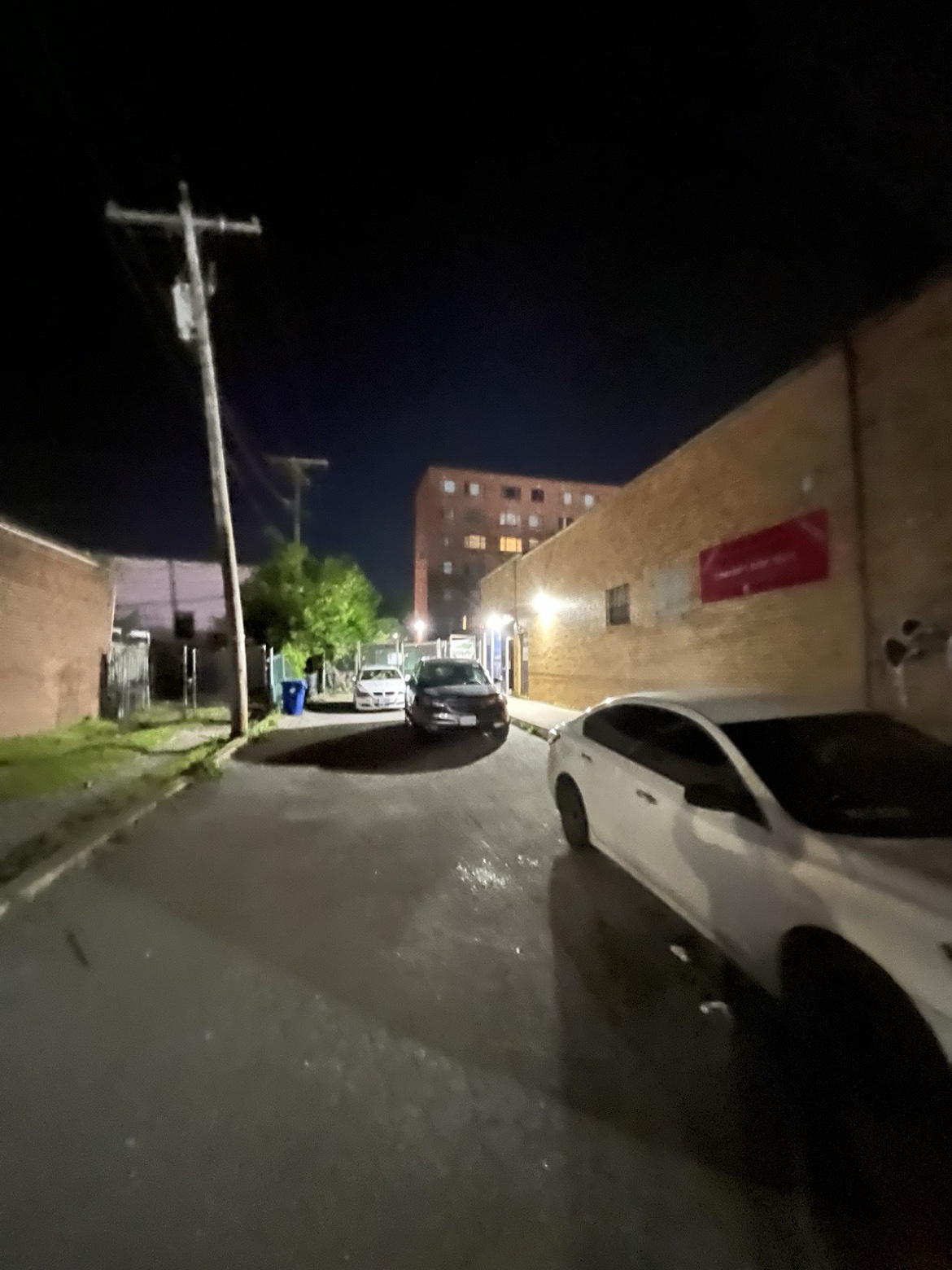 The street and alley approach to The Alley at night