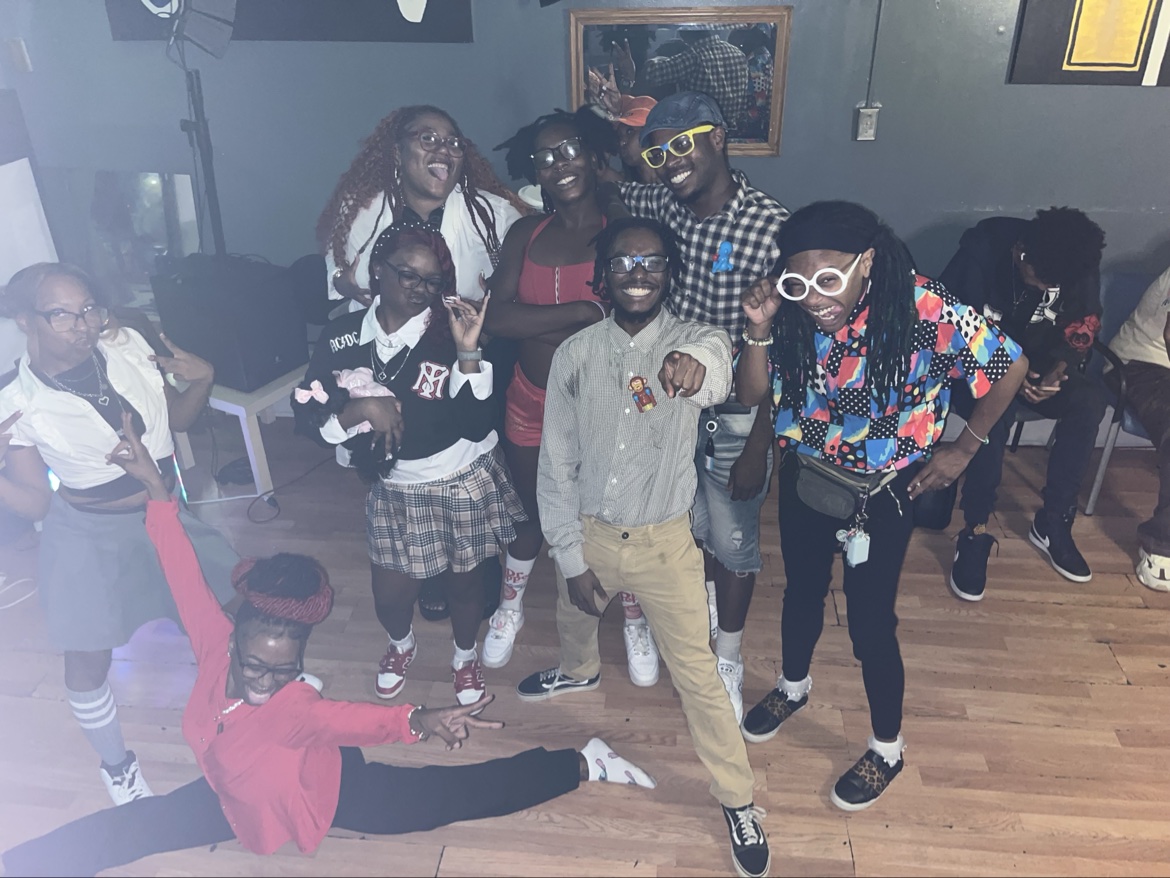 A large group posing inside during a themed party
