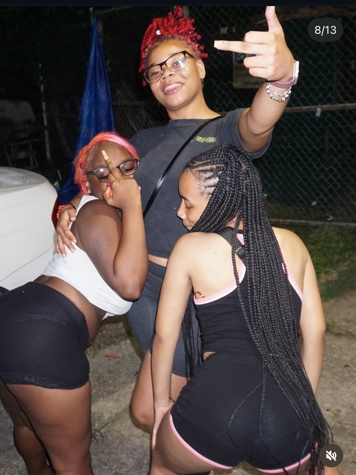 Three guests posing together outside at night