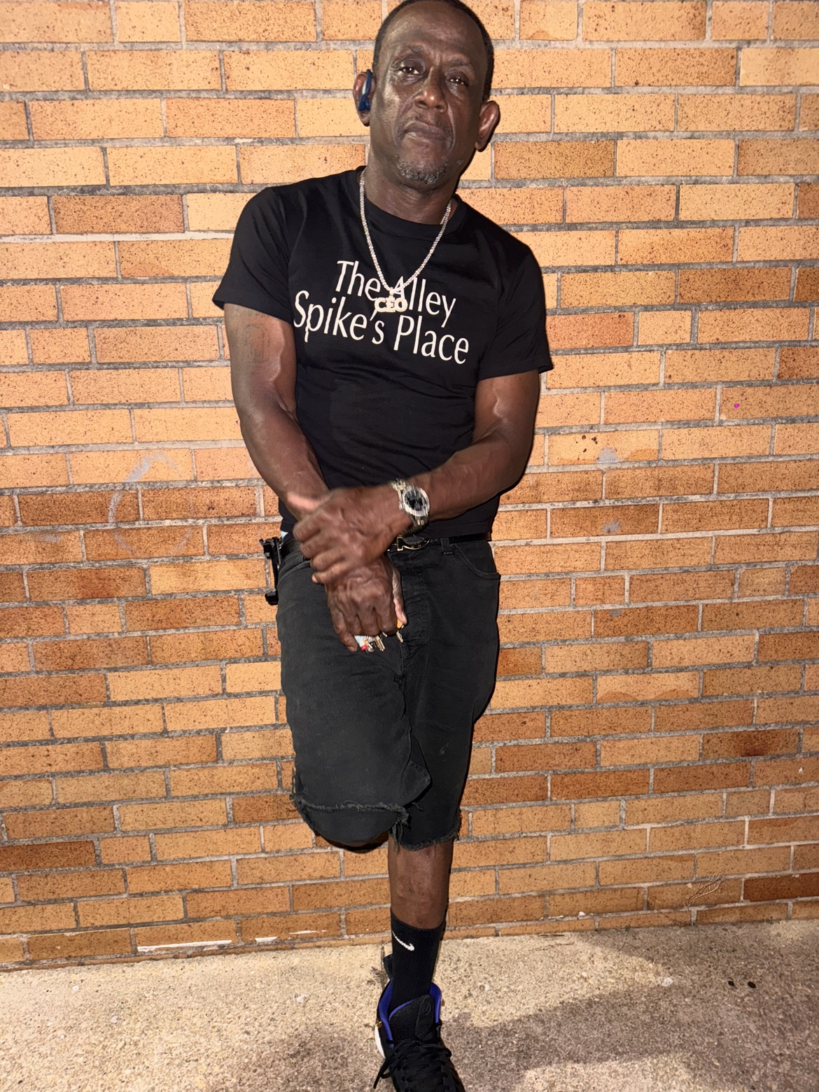 Spike outside wearing a black The Alley Spike's Place CEO shirt